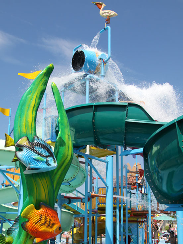 Splash pool from 0″ to 12″ of water with all interactive water play. Bridge connects different areas of lagoon and is located under the “Tipping Bucket” so participants can enjoy the timed water release or not!