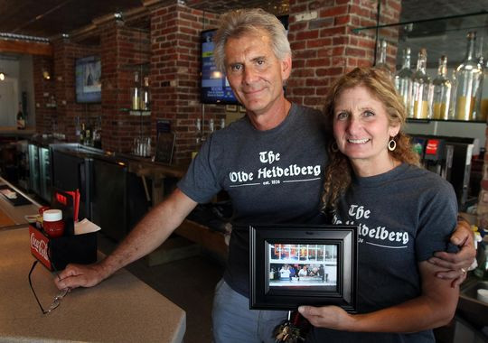 Allison Gehlhaus and her husband, Hank, hold a photo of Old Heidelberg Inn, a hot dog spot that opened in the 1930s and was destroyed by superstorm Sandy in 2012. Hank and his brother, Bill, reopened the famed hot dog spot at Keansburg Amusement Park earlier this month. THOMAS P. COSTELLO/STAFF PHOTOGRAPHER (Photo: THOMAS P. COSTELLO/STAFF PHOTOGRAPHER)