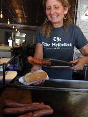 Allison Gehlhaus serves up a hot dog from the griddle at the reopened Olde Heidelberg in Keansburg. (Photo: THOMAS P. COSTELLO/STAFF PHOTOGRAPHER)